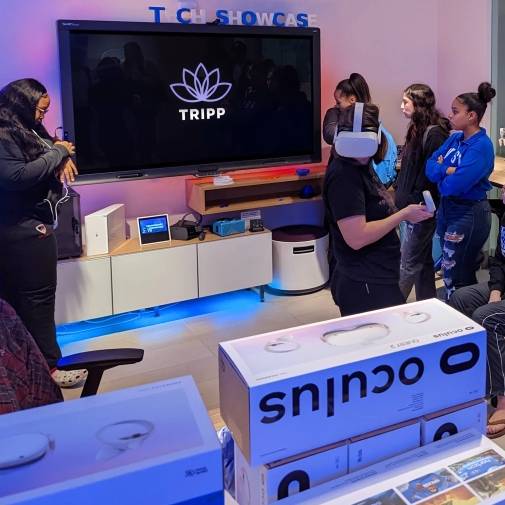 Student worker shows off Oculus Quest 2 as other students observe